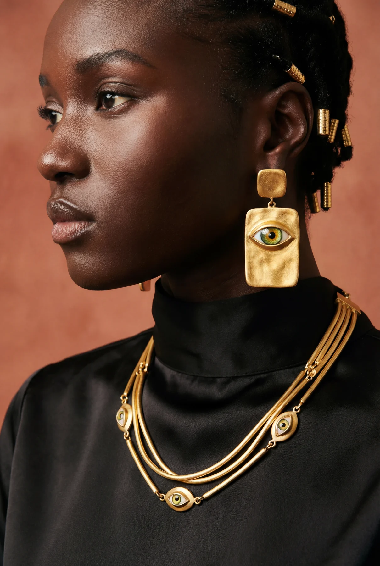 Sculptural gold jewelry beauty profile