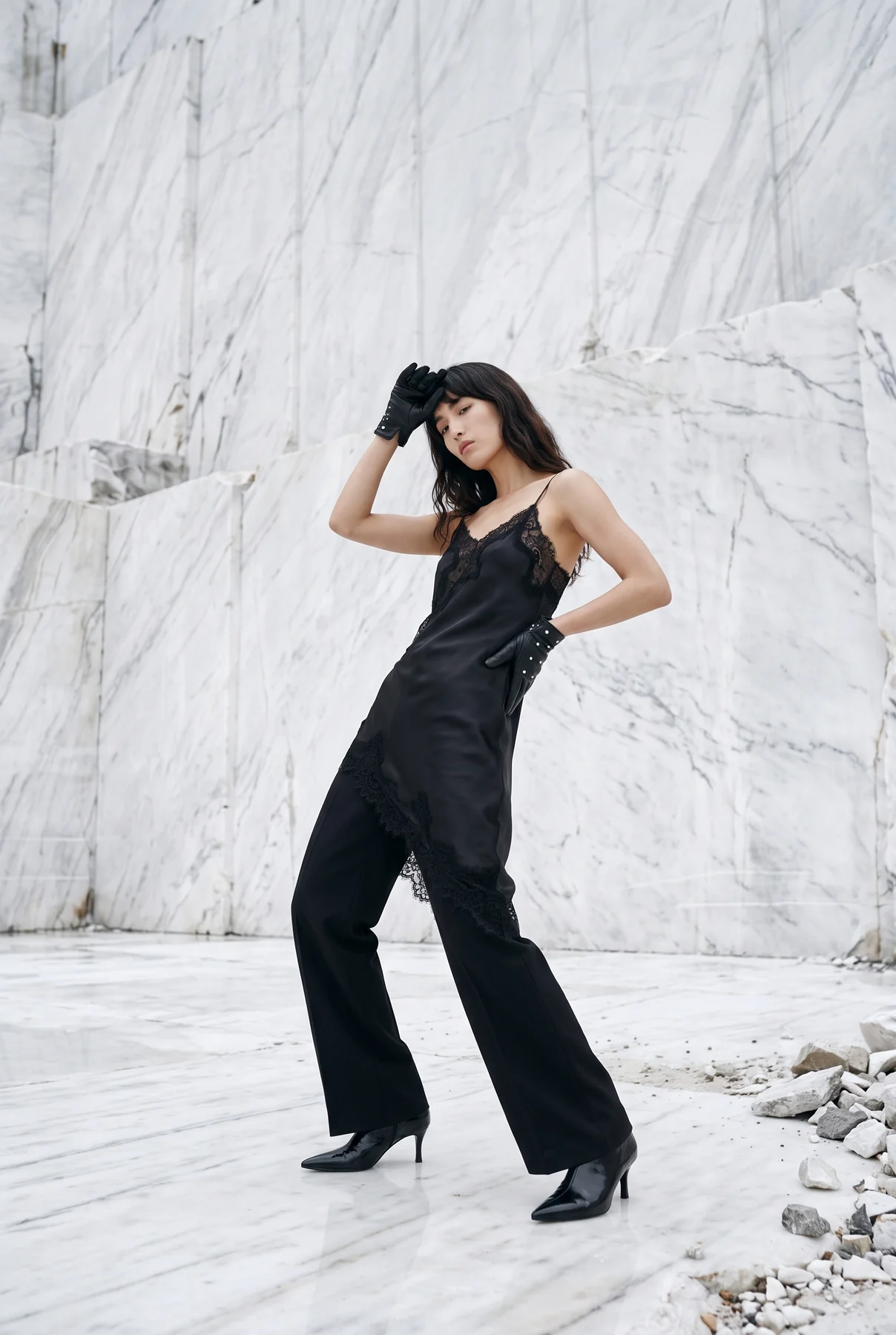 Black lace fashion portrait in a white marble quarry
