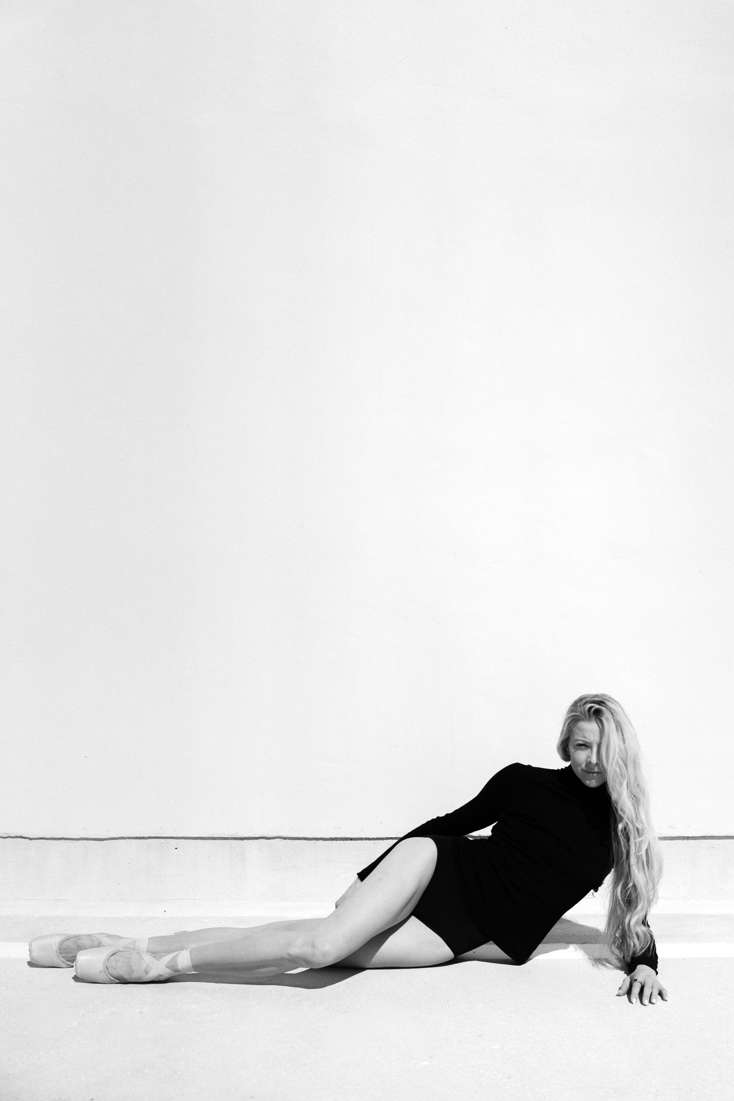 Black-and-white seated portrait with negative space