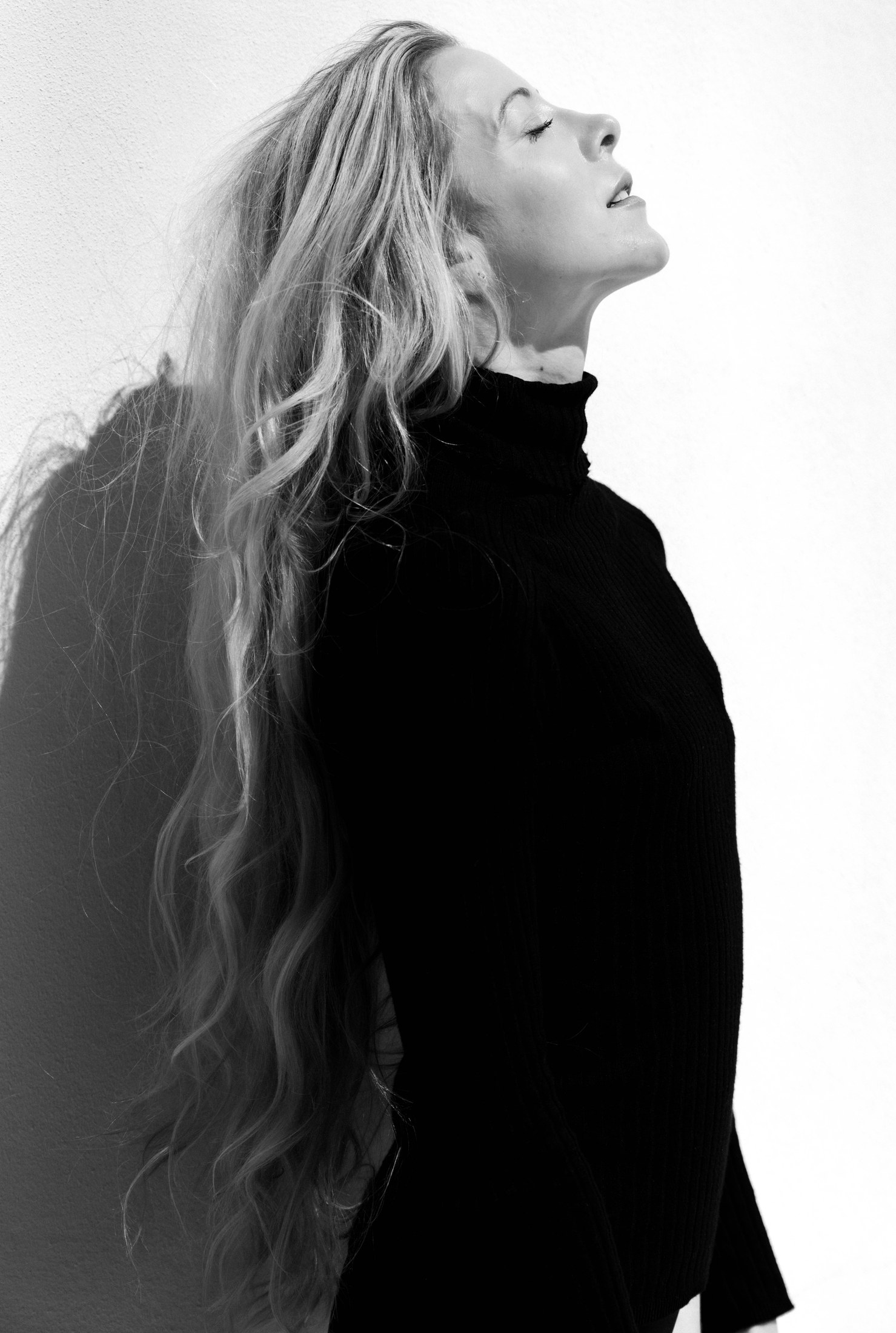 Black-and-white profile portrait with long blonde hair